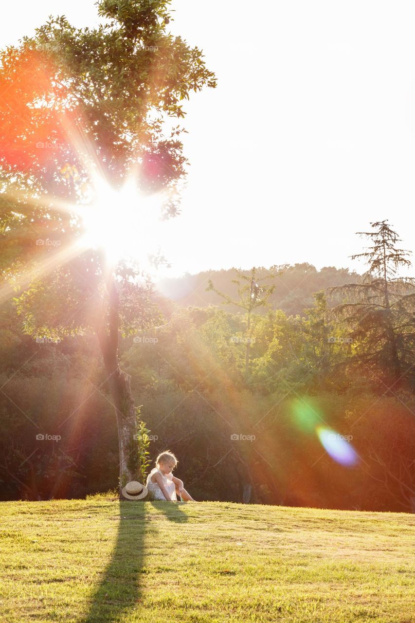 Happy kid relaxing in countryside at summer day 