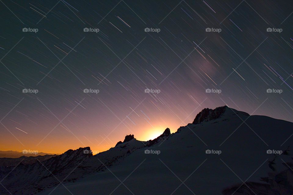 winter night with snow covered bed and dramatic sky above