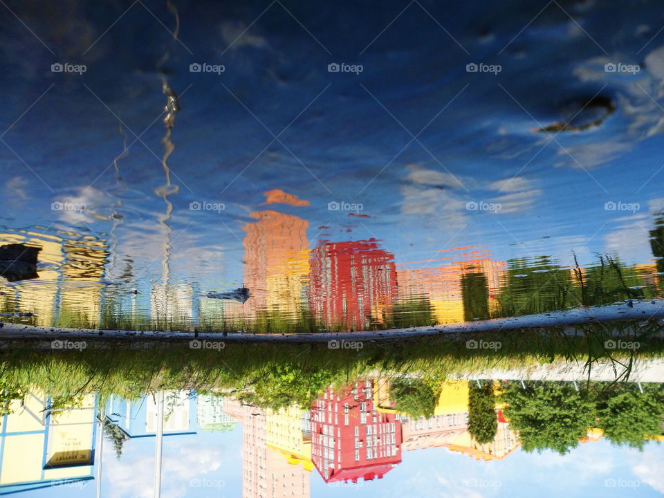 Reflection of a building in a puddle