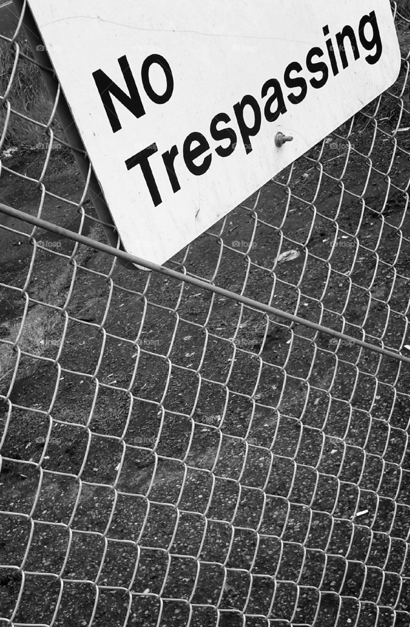 No trespassing sign on a fence.