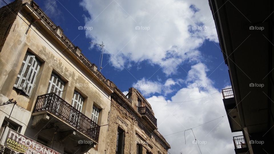 View of building with balcony and clouds