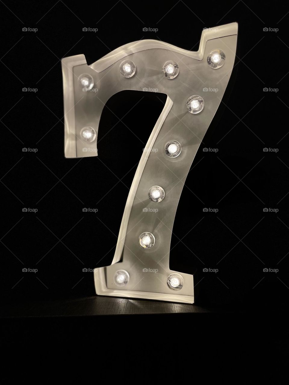 Round lightbulbs lit up on the number seven, circles in every day life, numbers that light up for home decor, lucky number seven, number seven decoration, fun shaped light