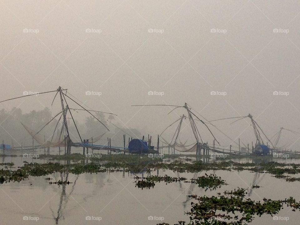 The very still & calm view of the ancient Chinese fishing nets in Kochin Kerala ...against misty dawn ..