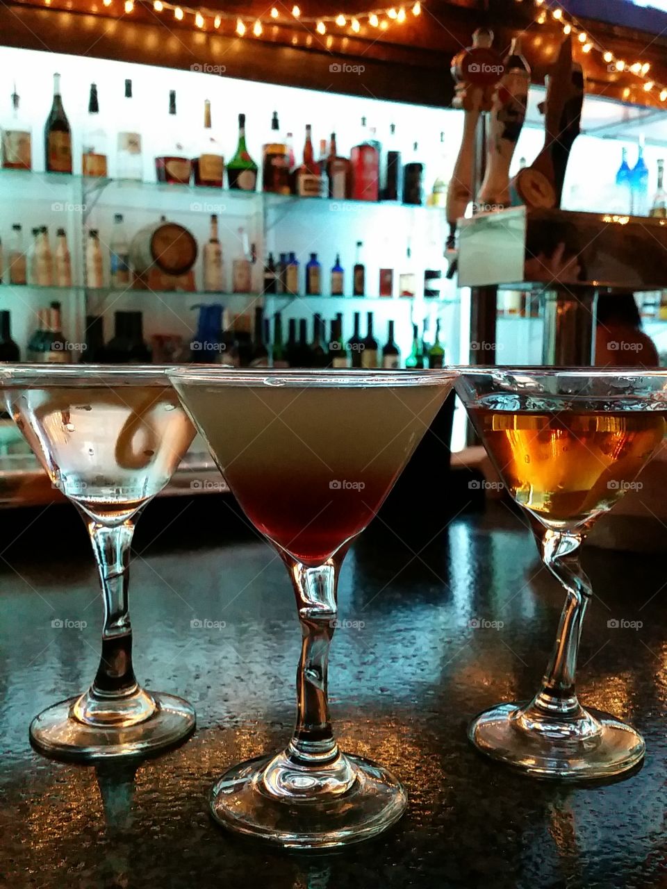 3 colorful martinis on the bar for New Years Eve