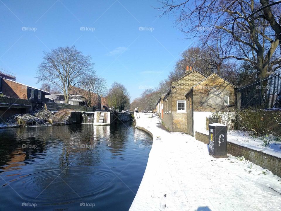 Walking along the canal in London in the snow