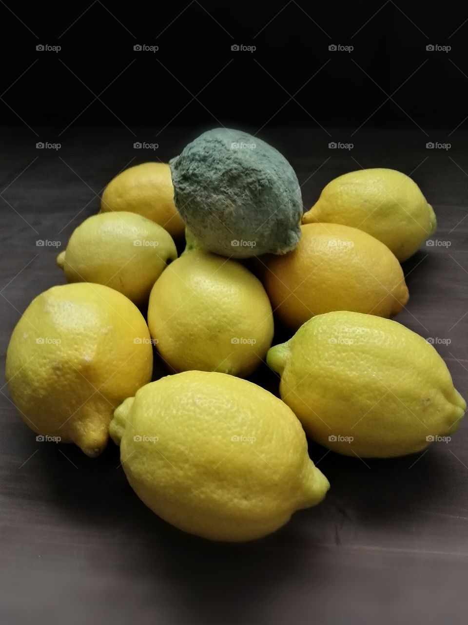 moldet lemon in the middle of good lemons