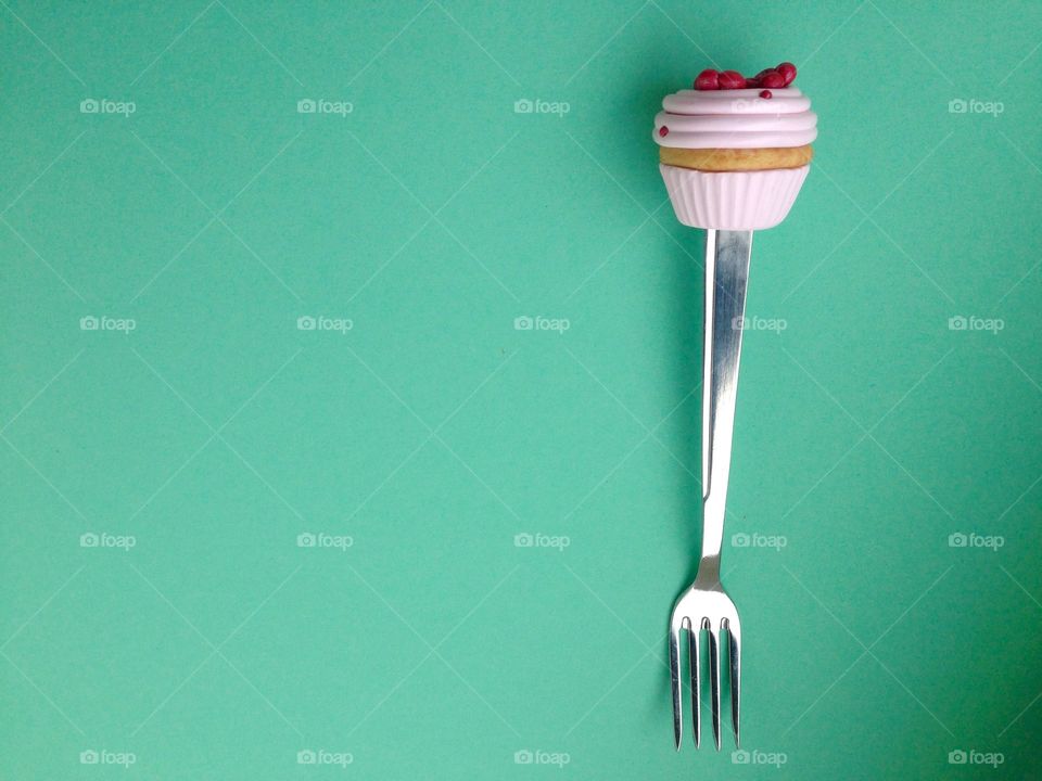 Fork on green background isolated 