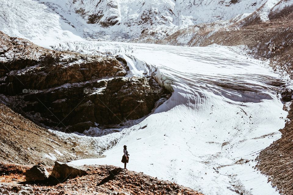 Little wanderer in awe of amazing view in swiss alps.