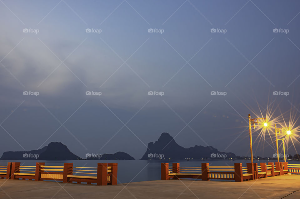 The lights on the bridge at night Background Sea and island at Prachuap Bay in Thailand.