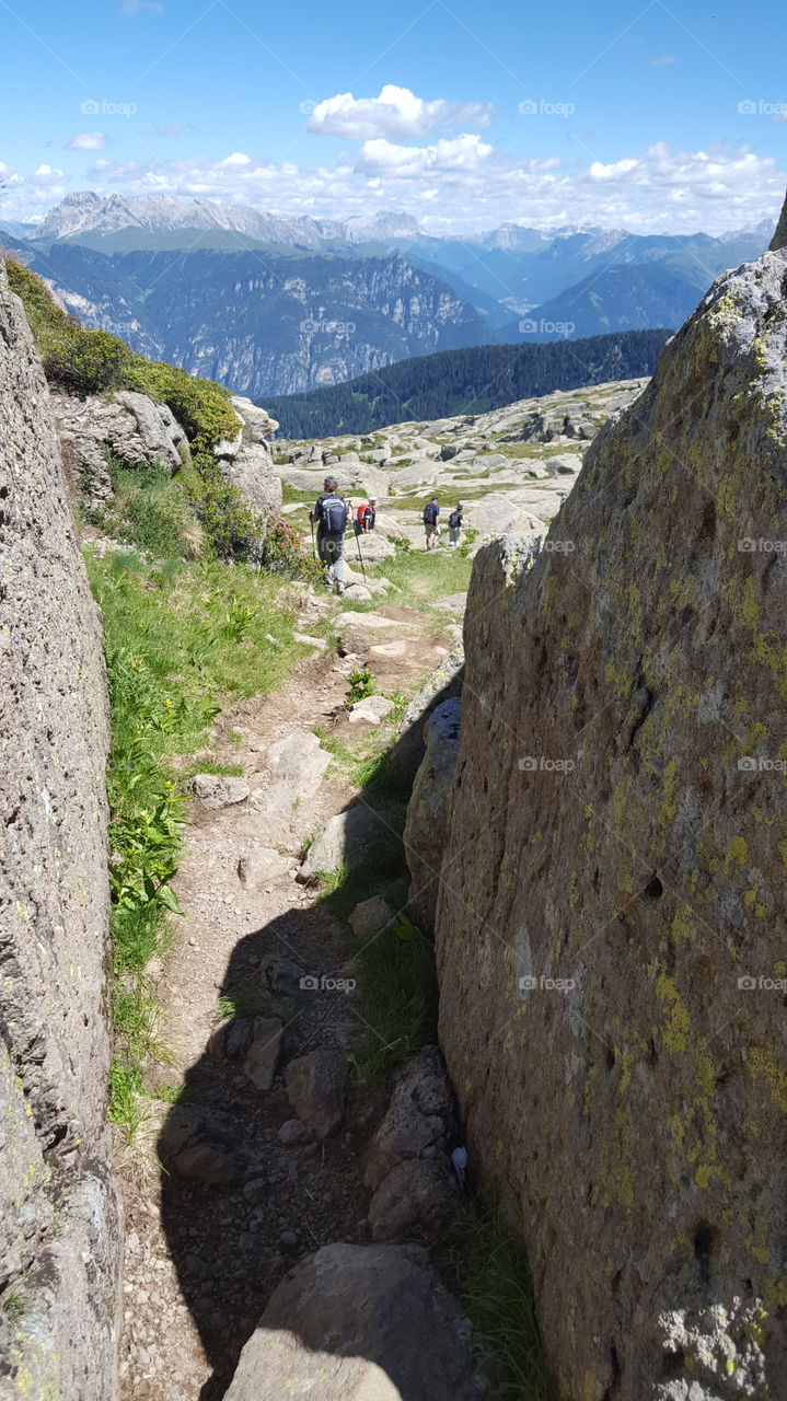 Hikers on a rocky hiking trail in the mountains 