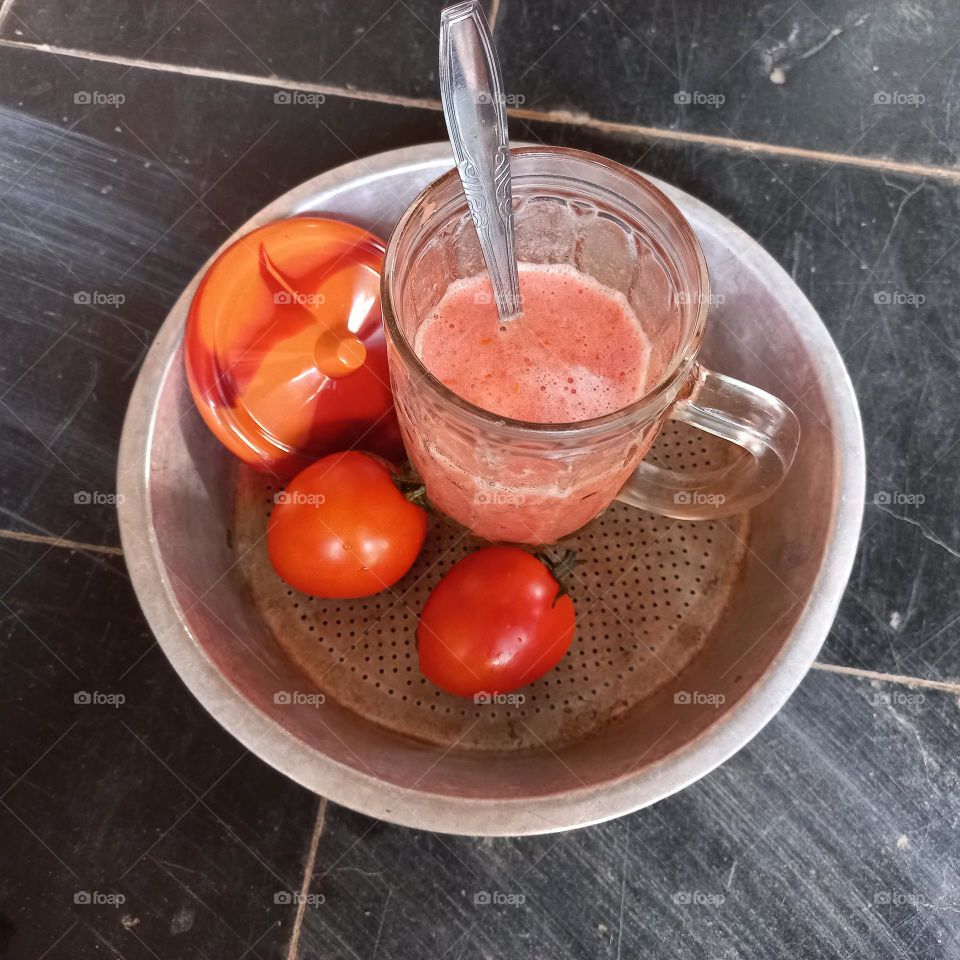 Tomato juice whose main ingredients are white sugar tomatoes and ice cubes