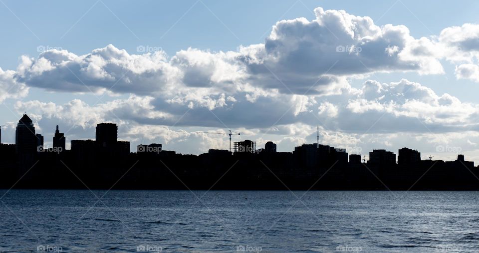 Urban nature, river and silhouettes of buildings on the horizon line 