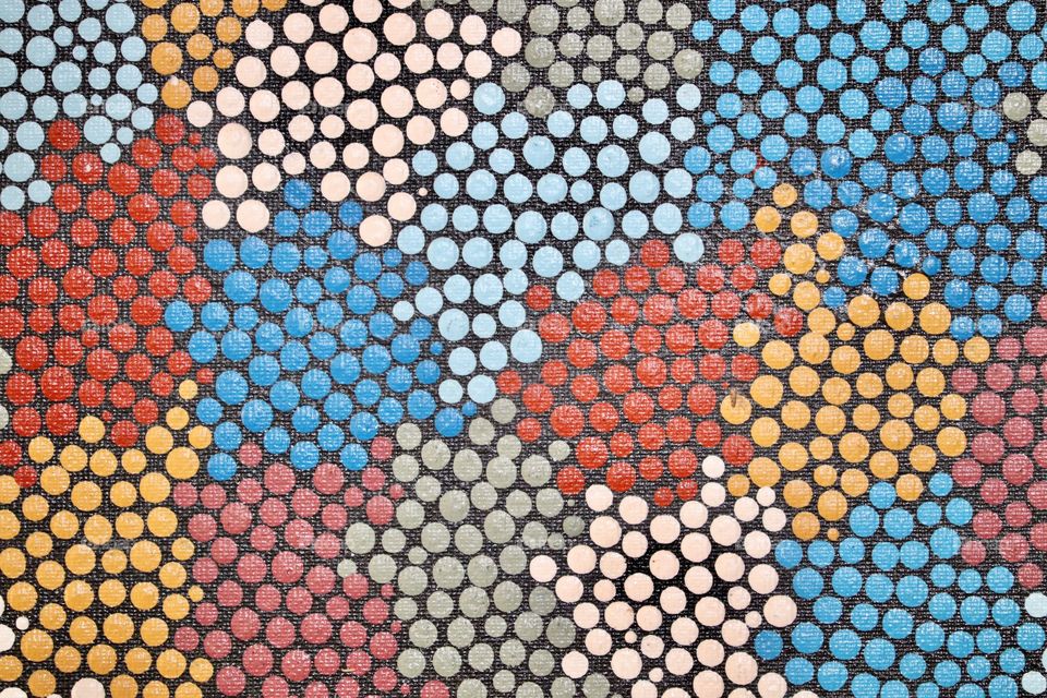 Texture surface closeup of aboriginal dot painting 