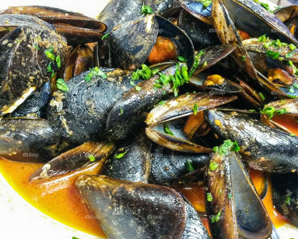 French cuisine: Close up of 'moules sautè avec pomme de terre'. mussels with tomato sauce