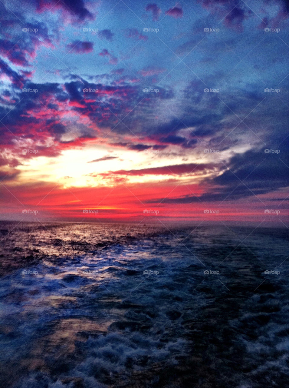 ocean sunset boat waves by spindola
