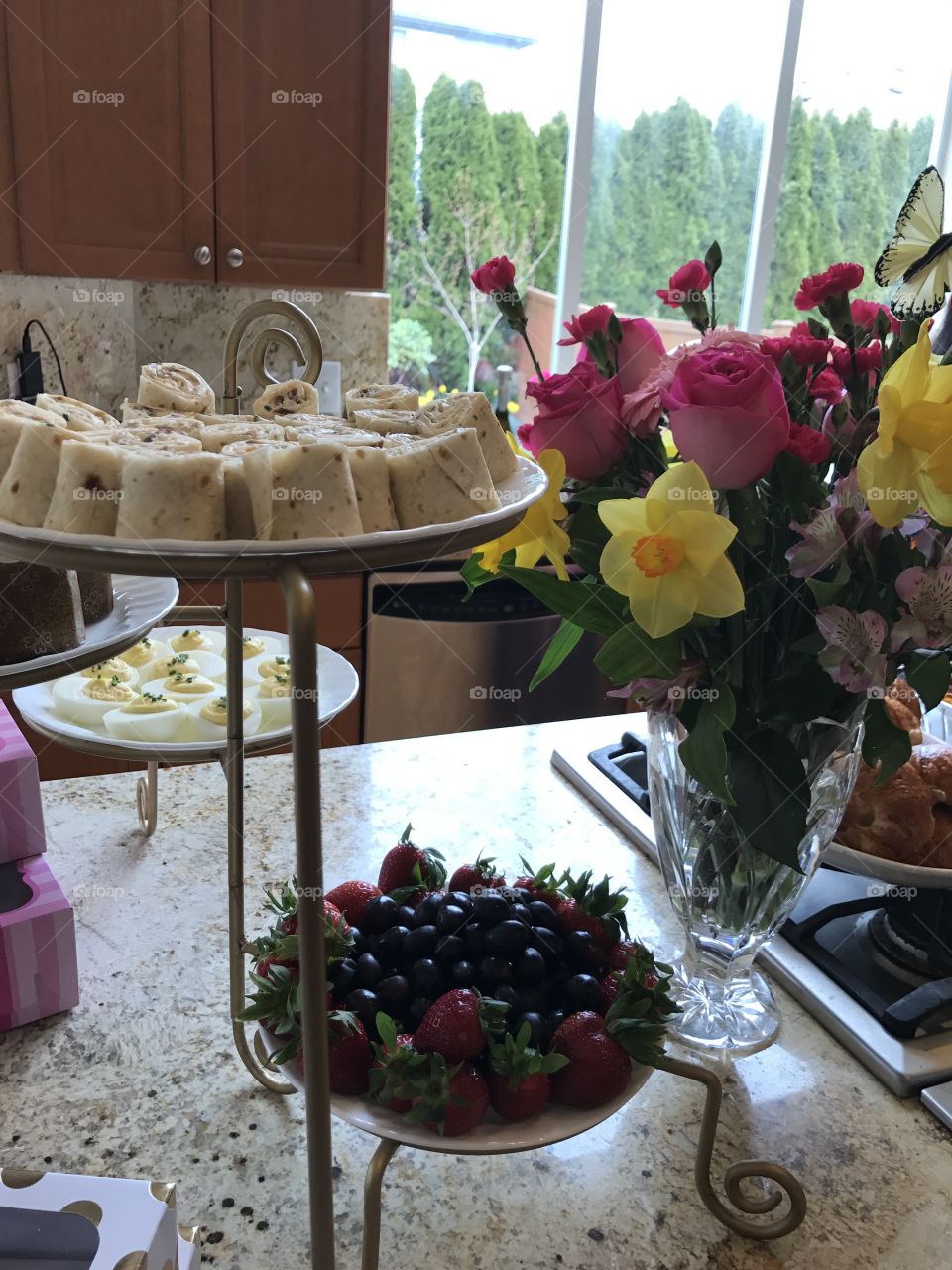 Afternoon tea party with delicious food. Deviled eggs, berries, strawberries, rolls