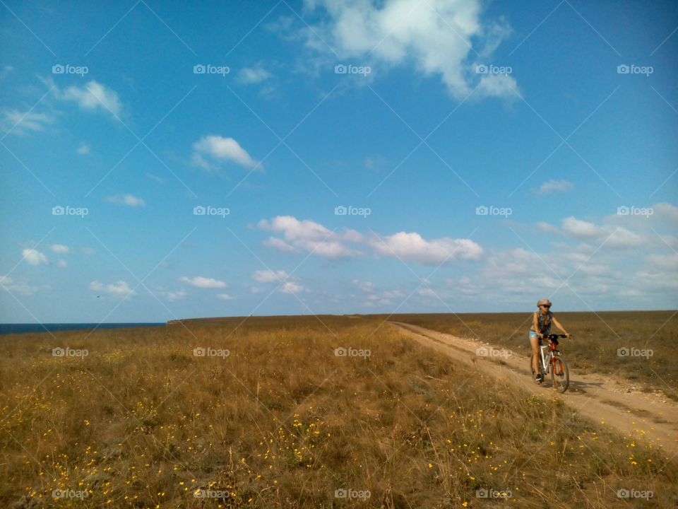 girl on a bike in steppe