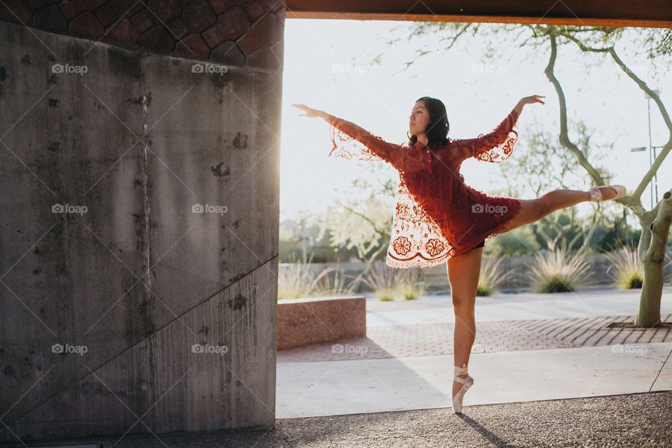 Young woman dancing with ballet shoe
