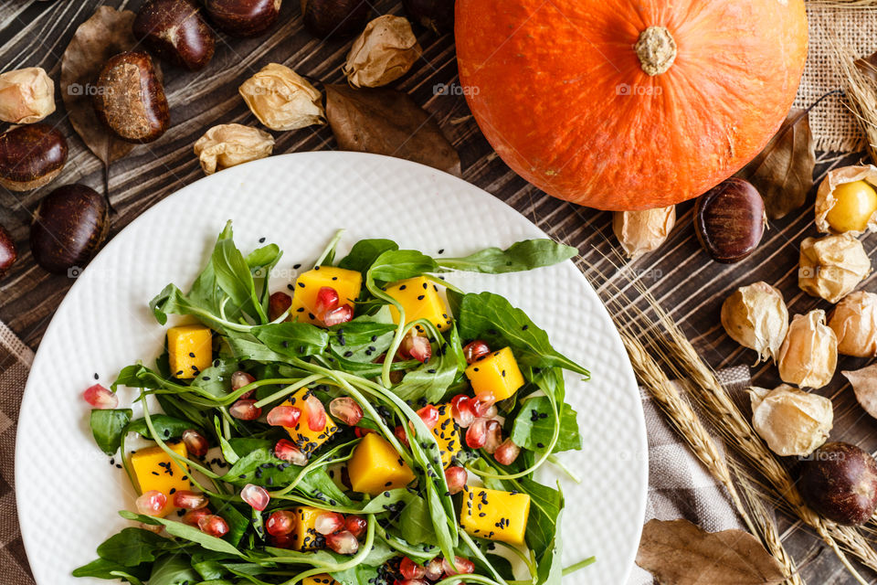 Food flat lay with salad and pumpkin 