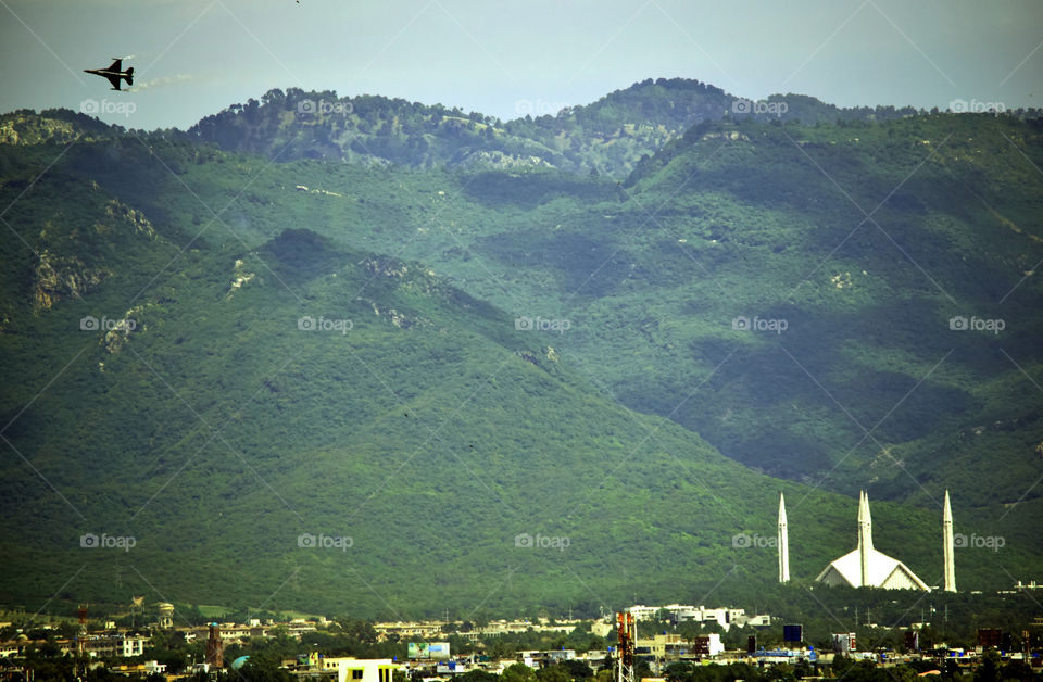 Islamabad on Defense Day. A PAF F-16 performing on Pakistan Defense Day in the Capital with the beautiful Margallah hills in the background.