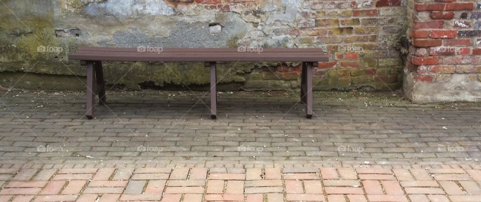 wood and stone. bench in courtyard in Shepherdstown