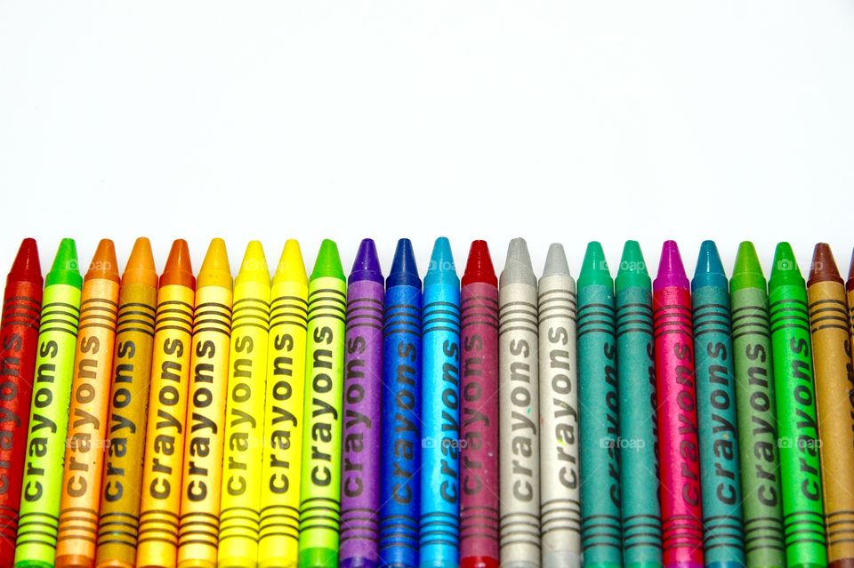 the crayons over the white background 
