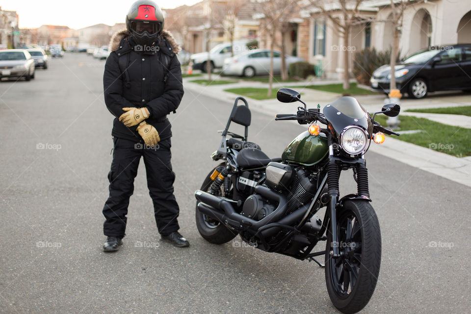 Biker with his bike in the street 