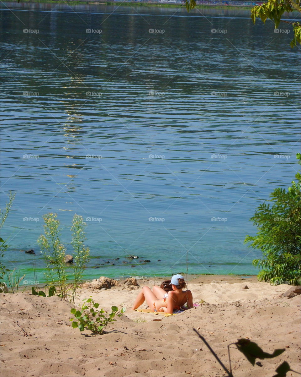 girl sunbathing on the plan in Hydropark in the city of Kiev