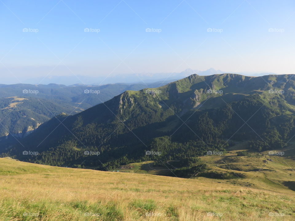 Mountain landscape valley and distant mauntain range