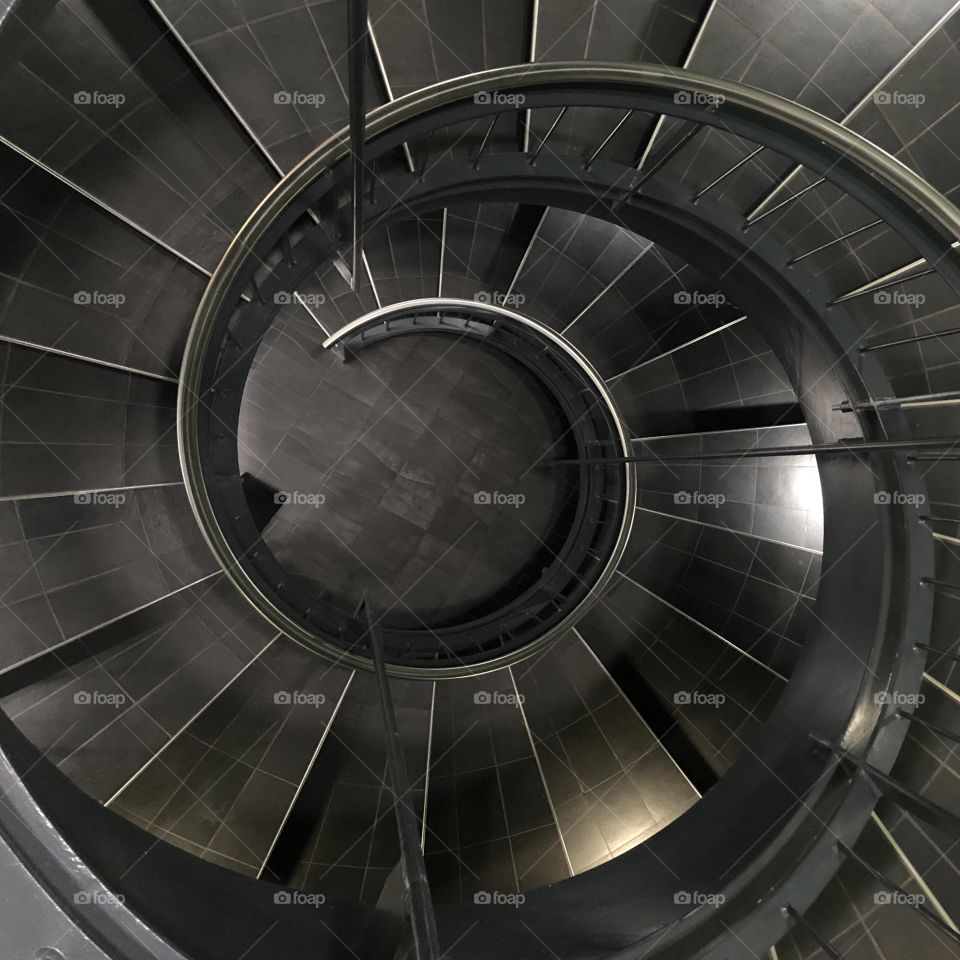 Spiral staircase with iron railing seen from above