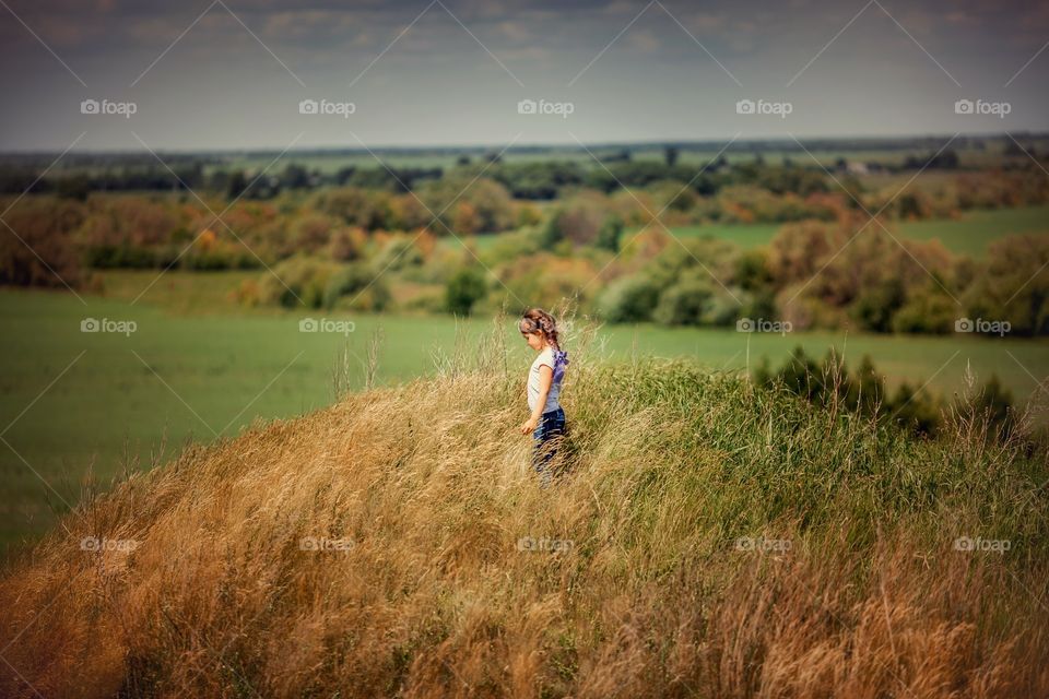 Little girl  in the summer field 