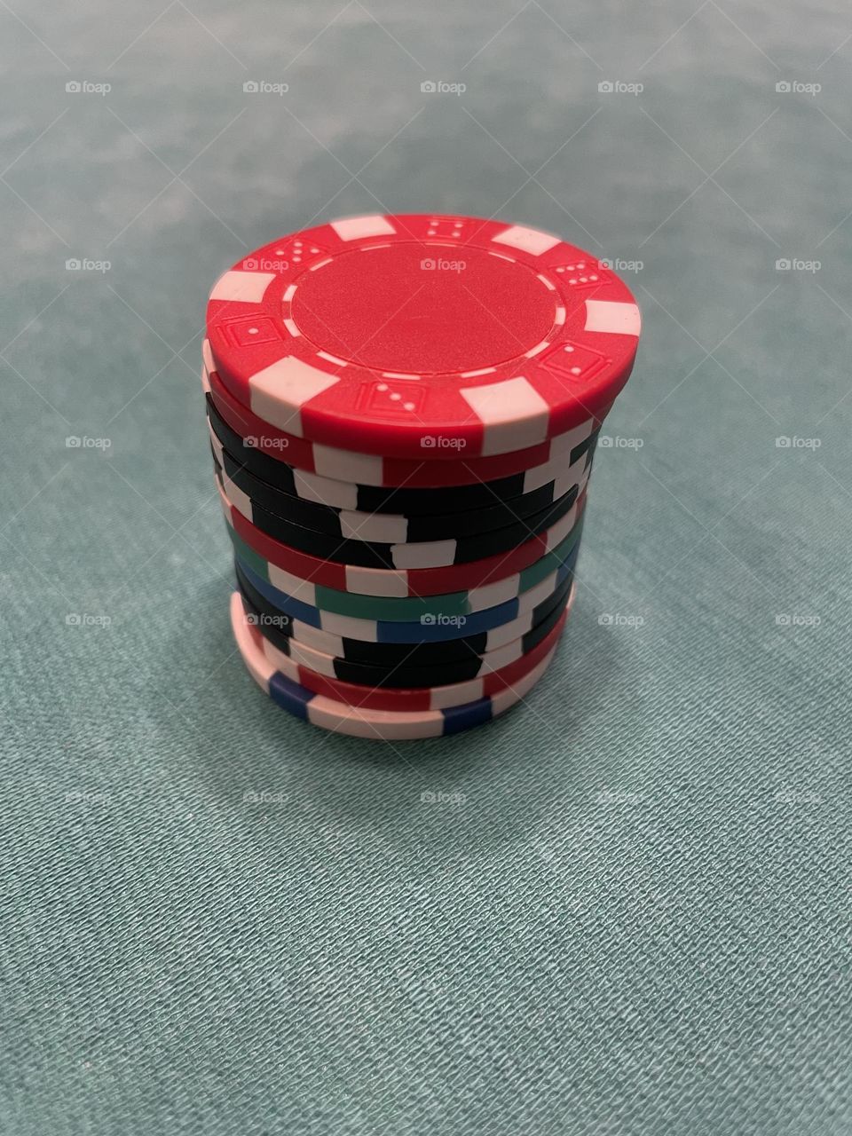 A large stack of multicolored poker chips