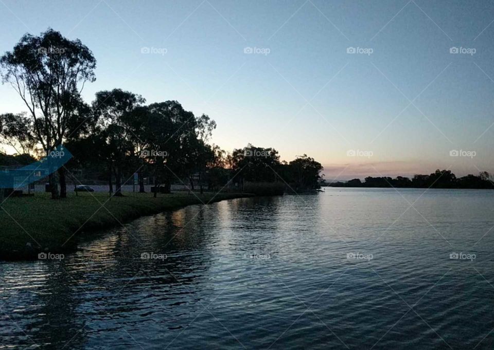 tranquil setting by the river watching the sunset