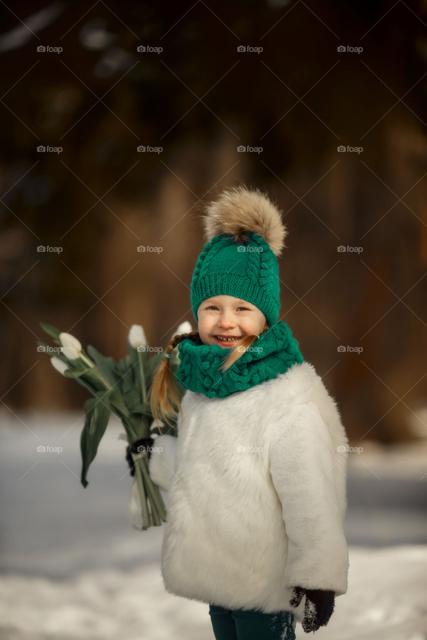 Little girl with tulips at early spring day