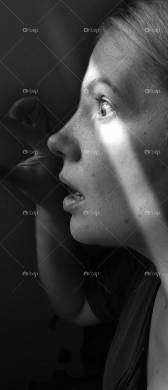 black and white photo of a girl in whose eyes shock