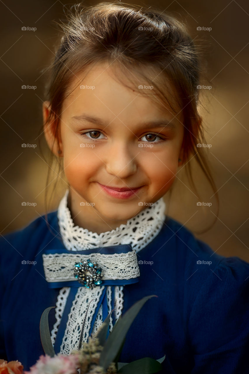 Little schoolgirl portrait  at a park 