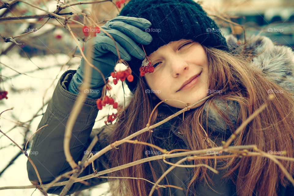 Portrait of a girl with winter berries