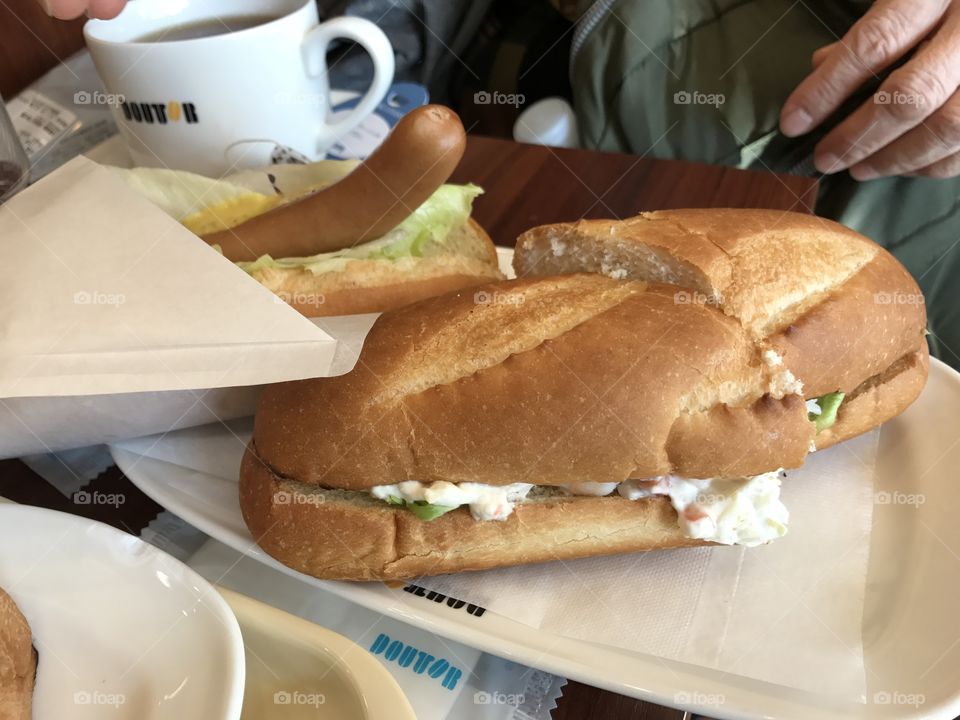 Hotdog, sandwich, and coffee for breakfast 