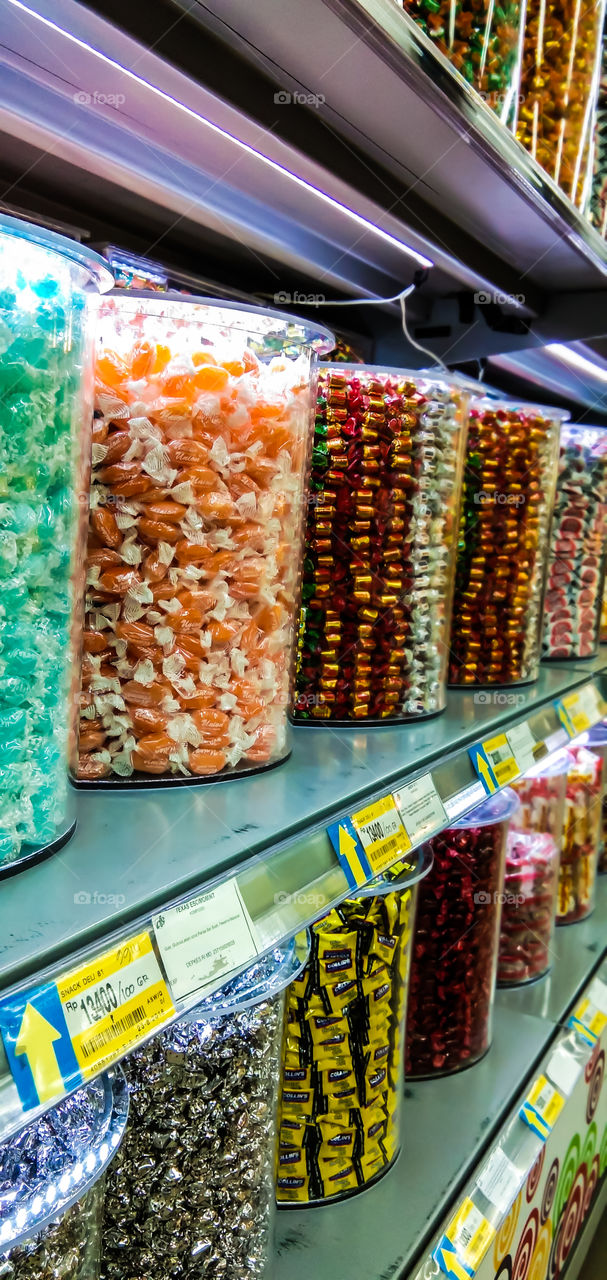 A variety of candies in jars with tempting colors