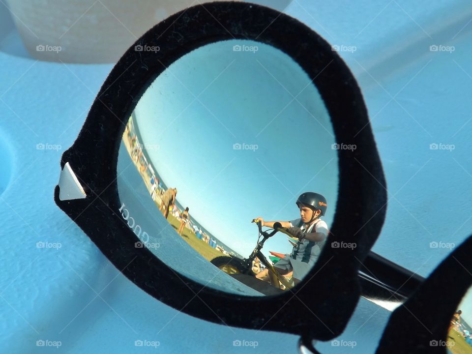 Reflection of the boy on the bicycle