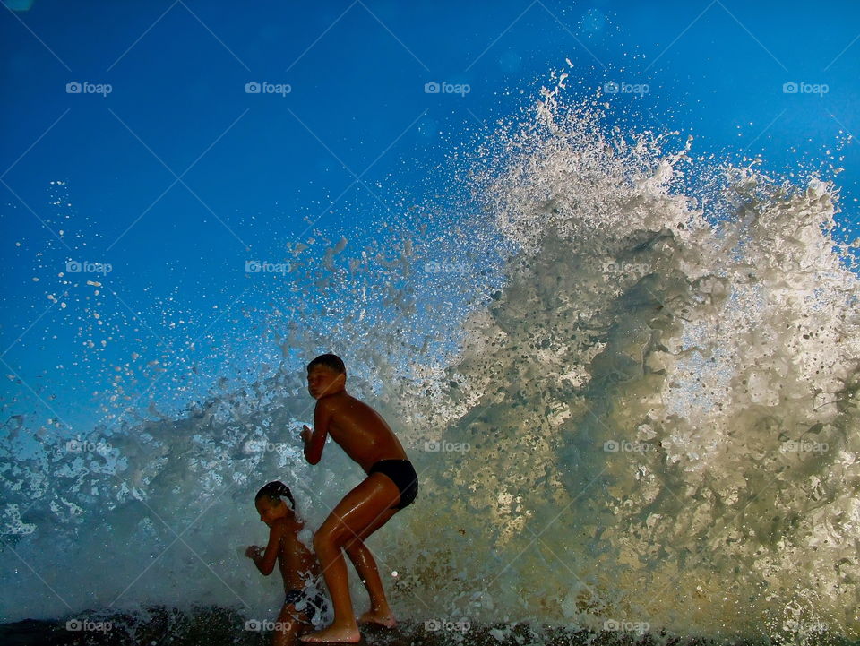children and waves
