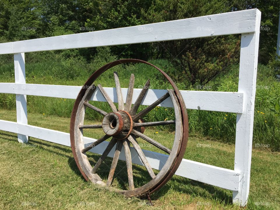 Wagon Wheel on Fence. Wagon Wheel on Fence