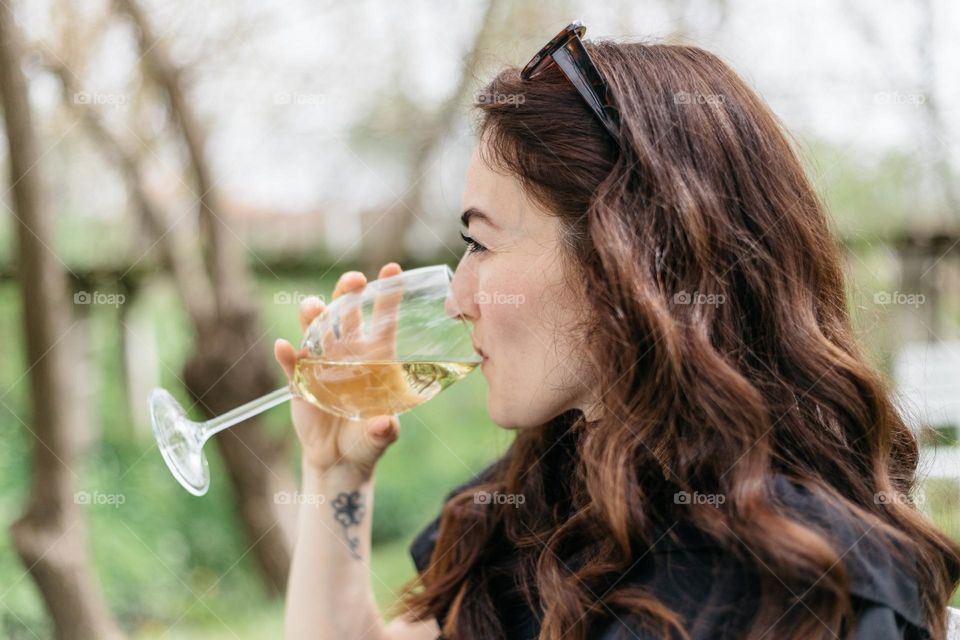 Woman drinking white wine.
