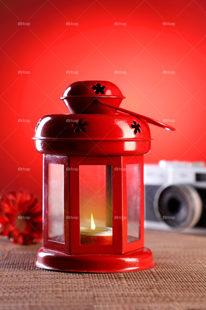 Red colored lantern lamp on red background