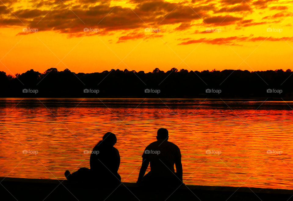 Sitting on the dock of the bay. A couple reminiscing and discussing life in general while sitting on the dock of the bay!
