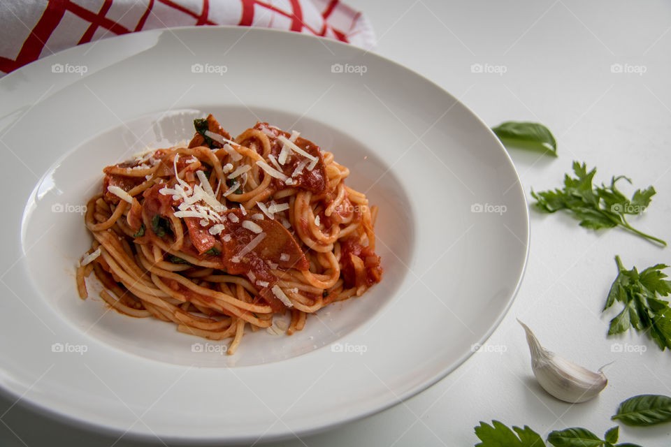 High angle view of pasta near garlic and vegetable