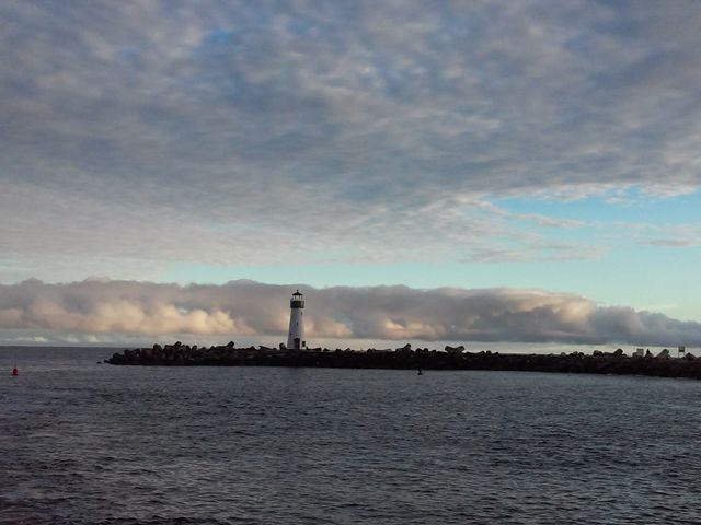 the fog bank. Looking out at the fog past the lighthouse in Santa Cruz harbor