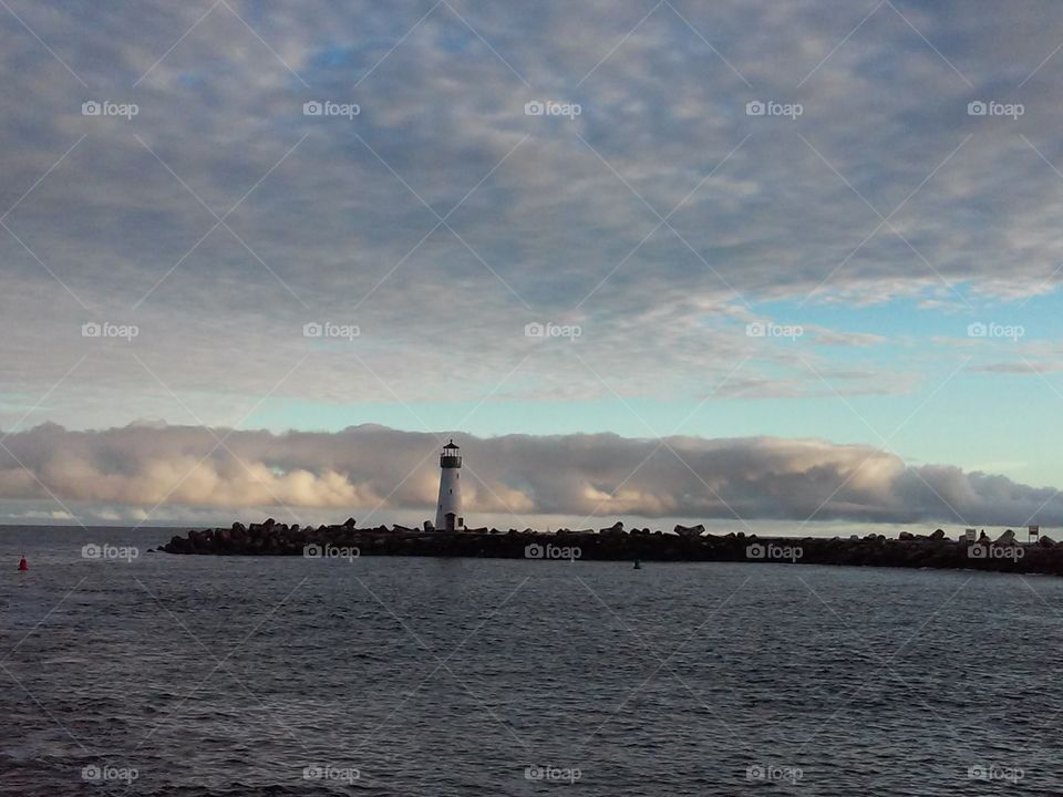 the fog bank. Looking out at the fog past the lighthouse in Santa Cruz harbor