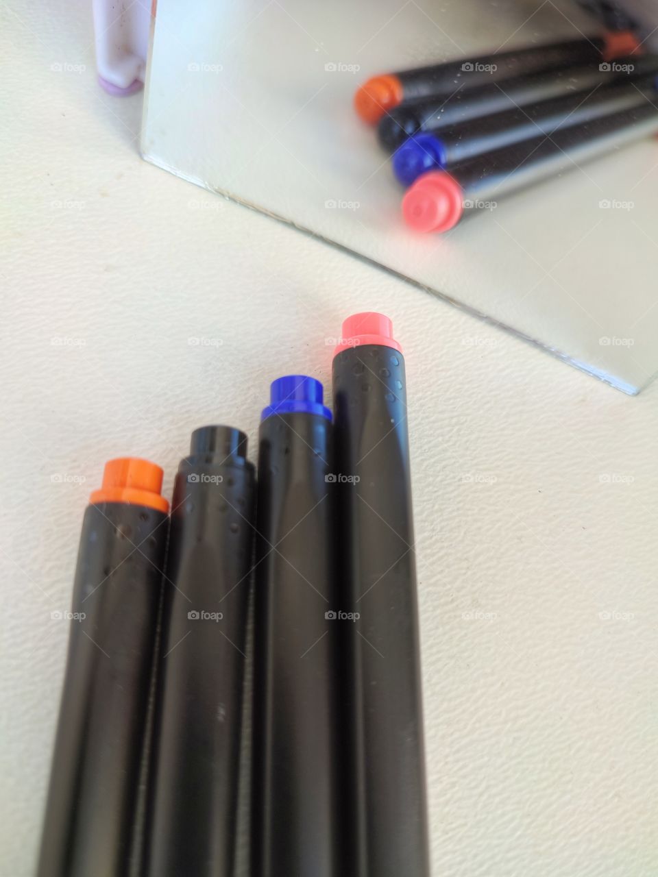 Colorful pens  with miror reflextion