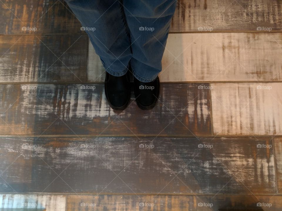 Black shoes standing on a vintage wood floor
